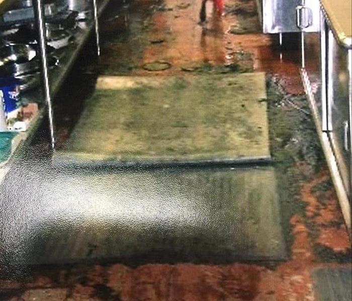 Sewage sludge on tile floor of kitchen in Cleveland business