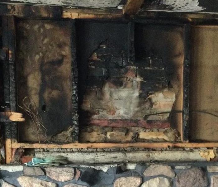 Fireplace with burned and charred wood around it